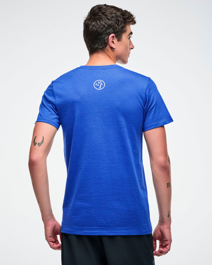 Back view of a male model wearing a blue t-shirt with a 'Zumbito' logo on the top against a white background.