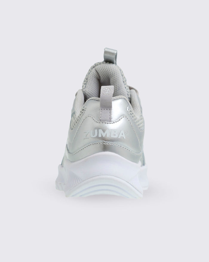 Silver sneaker with 'Zumba' branding on a silver pull tab and Zumba in small text on the heel.