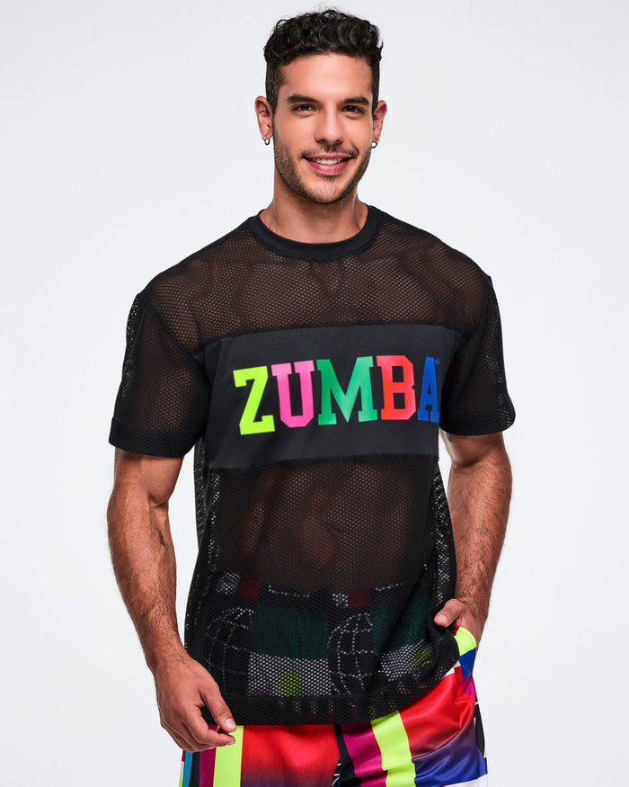 Male model wearing a black Zumba mesh shirt with colorful letters on a plain background.