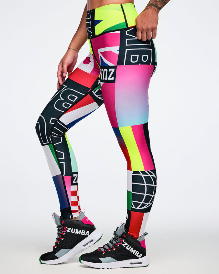 Colorful patterned leggings with 'Zumba' branding worn by a female model on a white background.