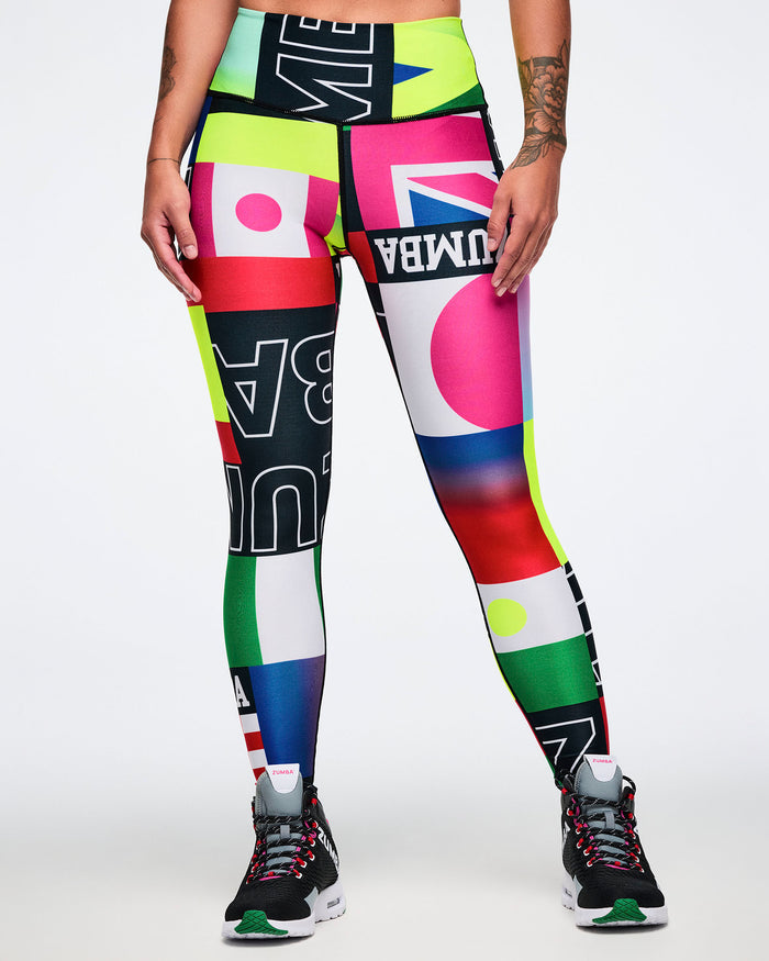 Female model wearing colorful patterned leggings with text and graphics on a white background.